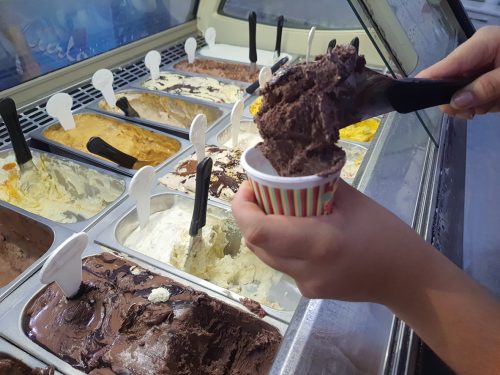 Morelli's ice cream store serving a scoop of chocolate ice cream