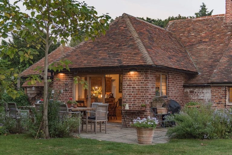 Countryside cottage in the early evening with lights