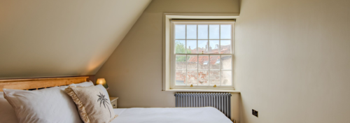 A cropped image of the attic bedroom in Narayan cottage Deal
